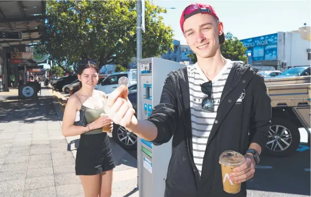  ?? Picture: STEWART McLEAN ?? SAVINGS: Siblings Shaye and Callum Amos of Bentley Park are pleased that CBD parking fees could remain unchanged.
