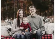  ?? PHOTO COURTESY OF A RAYE OF SUNSHINE PHOTOGRAPH­Y ?? Jordan Riley, the new head boys basketball coach at Heber Springs, sits with his wife, Kelsi, and their son, Drew.