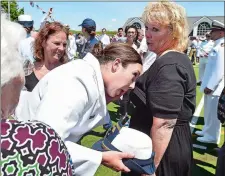  ?? TIM MARTIN THE DAY ?? Ensign Ashley Palmieri wipes her tears on the dress of her mother, Robin Palmieri. The Palmieri family is from Chester Springs, Pa.