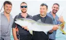  ?? Picture / Geoff Thomas ?? Torsten Sandmark, Mike Smeaton and Craig Dewar (far right) share Craig McDonald’s delight with his first kingfish.