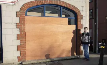  ??  ?? Selskar SVP shop manager Lillian Clowery at the boarded-up window.