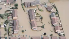  ??  ?? Evacuees trying to escape the floodwater­s in Houston, main image. An aerial view of Catcliffe near Sheffield following floods in 2007.