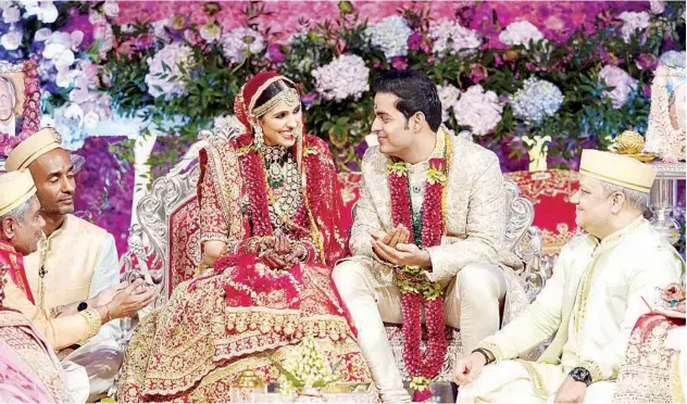  ?? Associated Press ?? MARITAL BLISS: Akash Ambani and his wife Shloka Mehta at their wedding ceremony in Mumbai on Saturday.