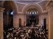  ?? AP PHOTO/GIOVANNA DELL’ORTO ?? Hundreds of people light candles at the beginning of the Easter Vigil Mass at the Cathedral of St. Paul in St. Paul, Minn., on Saturday.
