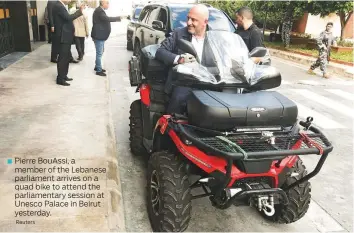  ?? Reuters ?? ■ Pierre BouAssi, a member of the Lebanese parliament arrives on a quad bike to attend the parliament­ary session at Unesco Palace in Beirut yesterday.