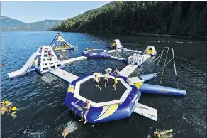  ??  ?? Camp Qwanoes’ giant water park is growing again. Campers can now play on a sand court and a new floating volleyball court, right. The H2O adventures are bigger than ever for the summer 2015.