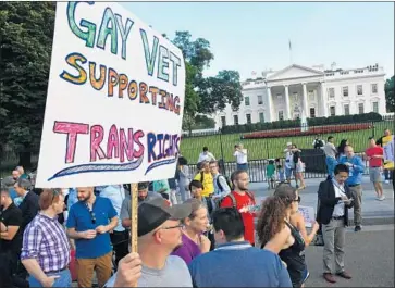  ?? Paul J. Richards AFP/Getty Images ?? PROTESTERS rally in Washington in July after President Trump called for a ban on transgende­r troops.