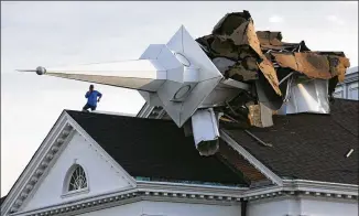  ?? CHICAGO TRIBUNE/TNS 2020 ?? A person surveys the damage Aug. 10, 2020, from the roof of College Church in Wheaton, Illinois, after a severe storm toppled the church steeple on the campus of Wheaton College.