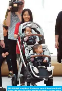  ?? — AFP ?? MELBOURNE: Conjoined Bhutanese twins fifteen-month-old Nima and Dawa and their mother Bhumchu Zangmo leave the Royal Children’s Hospital in Melbourne yesterday.