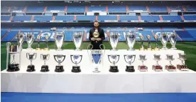  ?? Photograph: Realmadrid.com/AFP/Getty Images ?? Karim Benzema posing with his Ballon d'Or award and trophies during his farewell ceremony at Real Madrid.