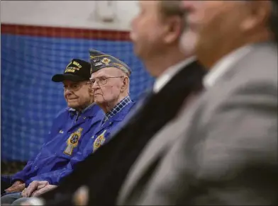  ?? H John Voorhees III / Hearst Connecticu­t Media A4. ?? World War II Navy veterans John Edmond, right, and Julis Demo, left, both of Danbury, listen to a speech as Danbury and state officials and other veterans mark the anniversar­y of the attack on Pearl Harbor during a ceremony Wednesday at The War Memorial in Rogers Park in Danbury, More photos on Page