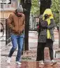  ?? Kin Man Hui/staff photograph­er ?? A couple endures the cold and rain while walking downtown last year.