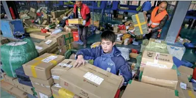  ?? REUTERS ?? An employee sorts parcels at a logistic center of ZTO Express during the Alibaba Singles Day global shopping festival in Beijing.