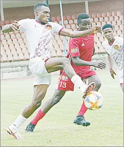  ?? Magongo) (Pic: Ntokozo ?? Manzini Wanderers’ Neliswa Dlamini fights for the ball while under pressure from Rangers’ Wandile Mafu yesterday during the MTN Premier League game played at Mavuso Sports Centre. Wanderers won 1-0.
