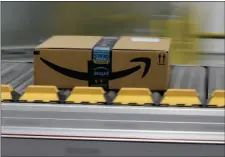  ?? AP PHOTO/RICH PEDRONCELL­I ?? In this Feb. 9 file photo, a box for an Amazon prime customer moves through the new Amazon Fulfillmen­t Center in Sacramento. President Donald Trump took another shot at Amazon.com on Thursday tweeting that the online retailer pays “little or no taxes”...