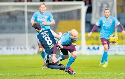  ??  ?? Shaun Byrne put in a crunching tackle on Hearts’ Steven Naismith in the opening minutes.