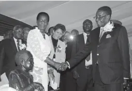  ??  ?? President Mugabe greets Ministry of Primary and Secondary Education permanent secretary Prisca Utete Masango at the 3rd education conference and expo in Harare yesterday. Picture by Innocent Makawa