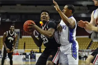  ?? IAN STEWART, SPECIAL TO THE RECORD ?? K-W Titans’ Ed Horton, right, blocks Windsor’s Shaquille Keith in Saturday’s final regular-season game.