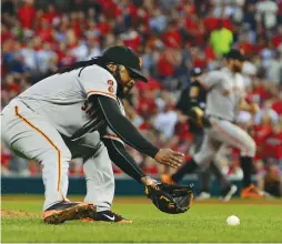  ?? (Reuters) ?? SAN FRANCISCO GIANTS starting pitcher Johnny Cueto fields a ground ball to help his cause as the Giants beat the St. Louis Cardinals on the road Friday night. Cueto is among four nine-game winners, joining Stephen Strasburg, Jake Arrieta and Chris Sale.