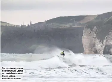  ?? MARGARET McLAUGHLIN ?? Surfers in rough seas below Dunluce Castle, as coastal areas await Storm Callum