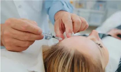  ?? ?? A plastic surgeon injects botox into a patient. Photograph: alexey_ds/Getty Images