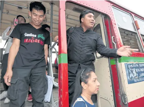  ?? CHANAT KATANYU ?? Student activist Sirawit Serithiwat, also known as ‘Ja New’, gets off a public bus provided by police to transport him to parliament to submit a petition demanding the National Legislativ­e Assembly (NLA) launch a no-confidence debate against the Prayut administra­tion.