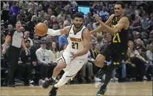  ?? RICK BOWMER — THE ASSOCIATED PRESS ?? Denver Nuggets guard Jamal Murray drives as Utah Jazz Darius Bazley defends during in the first half Tuesday in Salt Lake City.