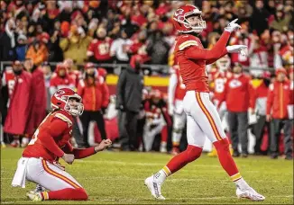  ?? BRYNN ANDERSON/ASSOCIATED PRESS ?? Chiefs kicker Harrison Butker (right) watches his winning 45-yard field goal against the Bengals on the last play of the AFC Championsh­ip game Jan. 29 in Kansas City, Mo. One week earlier, Butker made a potential touchdown-saving tackle on a kickoff return against the Jaguars.