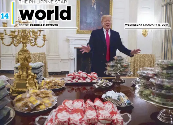  ?? AP ?? US President Donald Trump serves an ‘all-American feast’ of burgers and pizza to a football team at the White House on Monday. Trump, a fast food lover, said he paid for their meal himself because of the government shutdown.