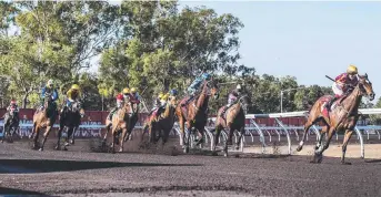  ??  ?? Jockey Raymond Vigar on winner of race 5 Ruth's Boy (second from right) at the home turn