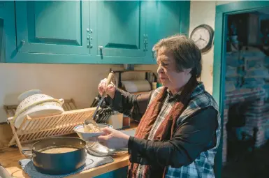  ?? JEENAH MOON/THE NEW YORK TIMES ?? Sharon Cohen, seen Jan. 21 at her Newtown, Conn., home says she “can’t just cut back on everything.”