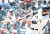  ??  ?? The Giants’ Brandon Belt connects for a two-run homer against Colorado Rockies starting pitcher Jon Gray.