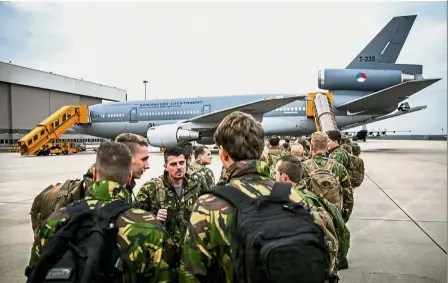  ?? — AFP ?? All aboard: Dutch soldiers departing with a KDC-10 tanker and transport plane from Eindhoven Airport in the Netherland­s to take part in Trident Juncture 18.
