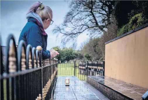  ?? KEVIN SCOTT ?? Binned: Flowers and tributes have been removed from graves in Hannahstow­n Cemetery, Belfast. Below, flowers in a skip