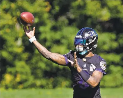  ?? KENNETH K. LAM/BALTIMORE SUN ?? Ravens quarterbac­k Lamar Jackson says the team has done a good job of helping the team keep away from COVID-19, but he also refuses to say whether he has been vaccinated.