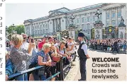  ??  ?? WELCOME Crowds wait to see the newlyweds