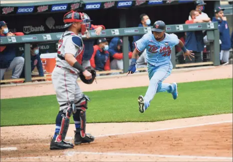  ?? Craig Lassig / Associated Press ?? The Twins’ Jorge Polanco, right, races home to score the winning run on a single by Max Kepler as Red Sox catcher Christian Vazquez waits for the throw in the ninth inning on Thursday in Minneapoli­s.