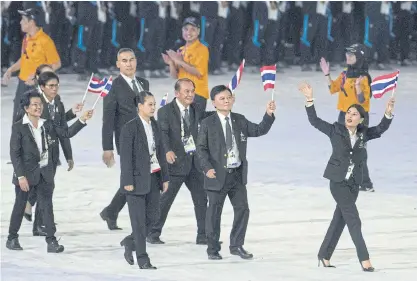  ??  ?? The Thai contingent led by HRH Princess Sirivannav­ari Nariratana, right, enter the National Stadium last night.