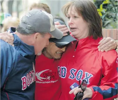  ?? JOHN MOTTERN/ AFP/ GETTY IMAGES ?? Runner John Ouano cries after he finds friends following several explosions that rocked the finish of the Boston Marathon on Monday. More than 2,000 Canadians, including 232 from B. C. were registered in the event.