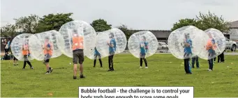  ??  ?? Bubble football - the challenge is to control your body zorb long enough to score some goals.