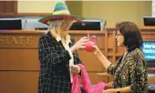  ?? TAMMY MURGA U-T ?? Chula Vista Mayor Mary Casillas Salas presents fun retirement gifts to Kelley Bacon on Tuesday.