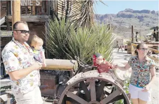  ??  ?? Michael and Jody Tucker, with son Luke, 3, and 1-year old daughter Rose, visit the old mining and ghost town of Oatman on their Route 66 adventure. Tricked out in custom-made Route 66 shirts sewn by Jody’s mom, the family made detours to explore as...