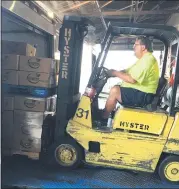  ?? SUBMITTED PHOTO ?? Lansdale Warehouse Company Transporta­tion Manager Dean Mengel loads a pallet of locally sourced peaches and blueberrie­s onto a truck delivering to Norristown area food pantries.