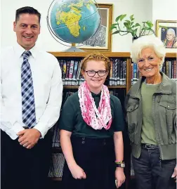  ??  ?? Mary Scheuren stands between Holy Name Principal Joe Carlson (left) and Delta County Cancer Alliance President Cheri Severinsen at Holy Name School in Escanaba, Michigan. Scheuren is wearing one of her Mary’s Fairy Scarves, which she creates, sells,...