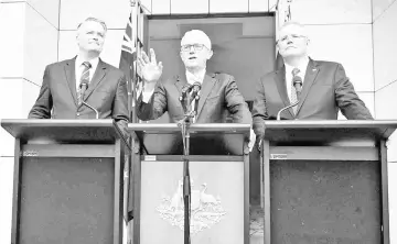  ??  ?? Turnbull gestures as he speaks at a press conference beside Cormann (left) and Morrison in Parliament House in Canberra. — AFP photo