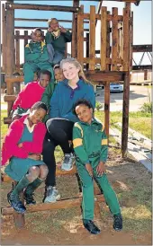  ??  ?? SPACE TO PLAY: Jennifer Yates enjoys the new outdoor area at Vusumzi Primary School with some of the pupils