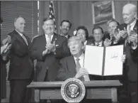  ?? AP/CAROLYN KASTER ?? President Donald Trump displays a signed Antiquitie­s Executive Order during a ceremony Wednesday at the Interior Department.