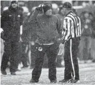  ?? David Zalubowski, The Associated Press ?? CU football coach Mike Macintyre confers with Pac-12 line judge Steven Kovac during the Buffs’ Nov. 17 home game against Utah. Macintyre was fired the next day.