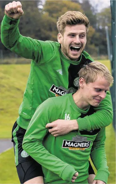  ??  ?? SCORING BURDEN: Stuart Armstrong gets a lift from team-mate Gary Mackay-Steven at Celtic training