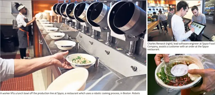  ??  ?? A worker lifts a lunch bowl off the production line at Spyce, a restaurant which uses a robotic cooking process, in Boston. Robots can’t yet bake a souffle or fold a burrito, but the new restaurant in Boston is employing what it calls a...